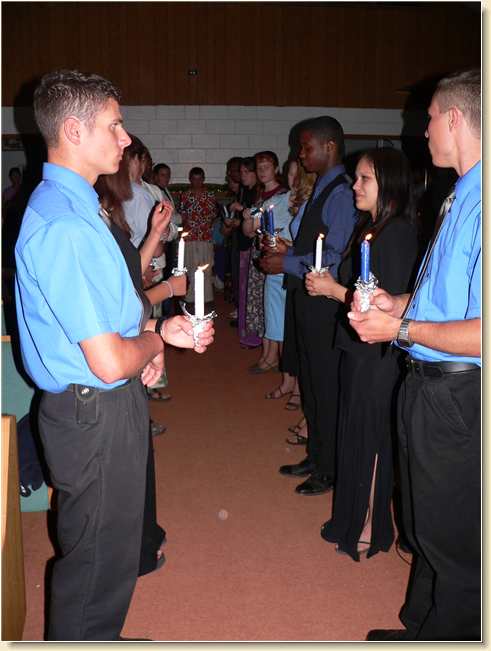 Graduates Daniel & Kyle passing the light to fellow students