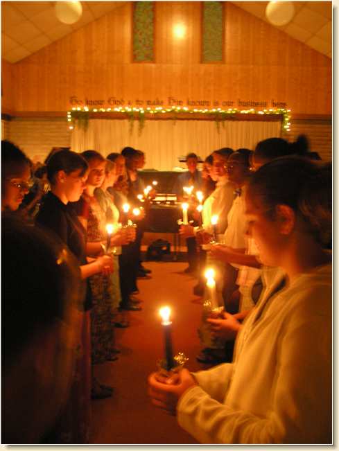 DayStar students holding candles at graduation