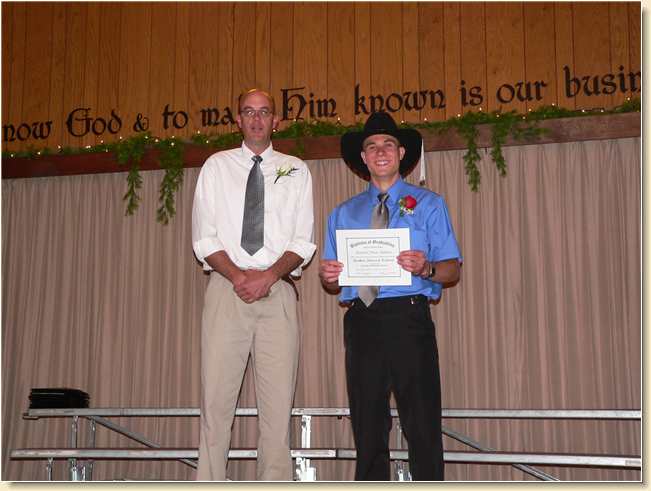 Jerry Harris with Daniel Adams holding diploma