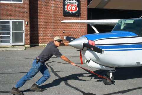 Daniel Adams pushing plane in northern Maine