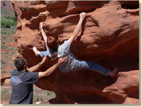 Daniel guards Heidi Hunt as she attempts a difficult climb
