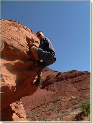 Daniel Adams partway up the boulder