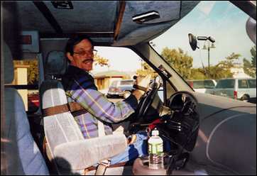 Fred Adams in his Ford van equipped with hand controls, enabeling him to drive in spite of quadriplegia