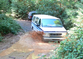 Fred Adams in handicap van splashing through puddle