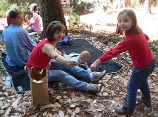 Alyssa shows her mom a caterpillar she discovered.