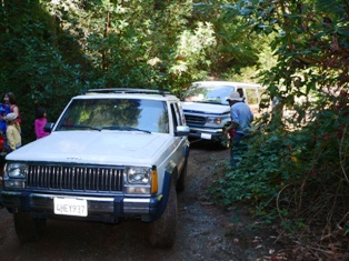 Jackie's Jeep pulling Fred's van out of the mud puddle