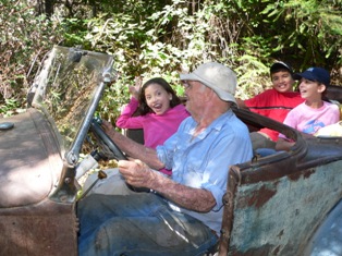 Celian Adams with kids in 1930 Ford Model A Roadster