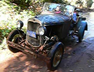 Ford Roadster exiting puddle near Deer View